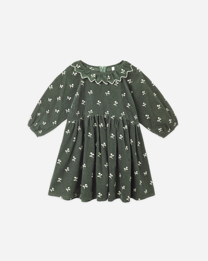 Evergreen Freya corduroy dress with ruffle collar, balloon sleeves, and floral embroidery.